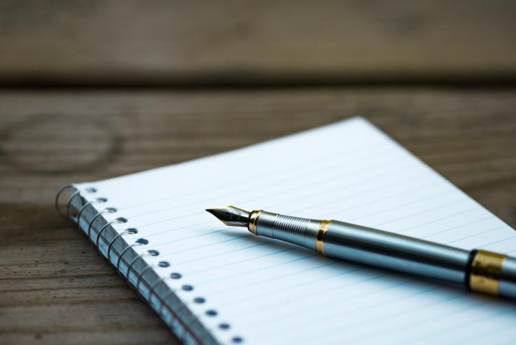 pen and blank paper in notebook