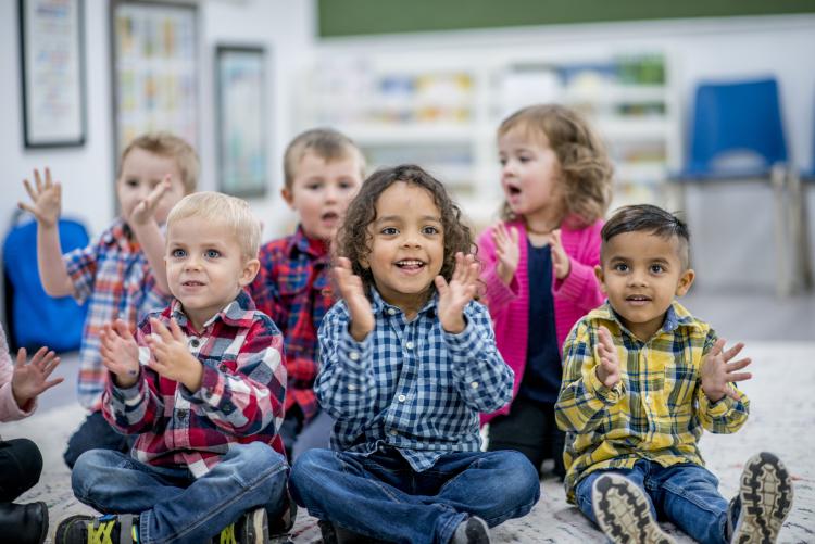 children in classroom clapping