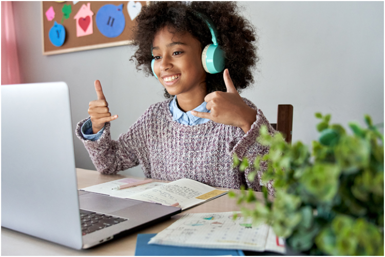 Woman giving thumbs up to computer